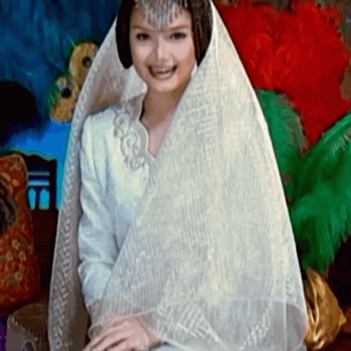 an image of a woman sitting down wearing a wedding gown