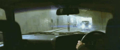 a vehicle traveling on a road through a tunnel