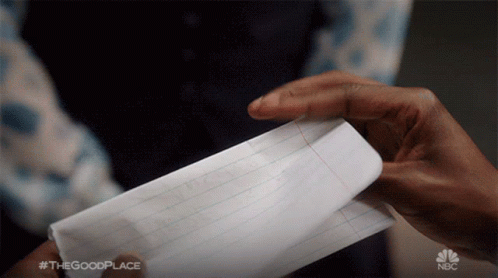 the hands of two people that are touching some paper
