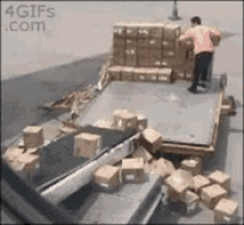 man standing in front of some boxes on a dock