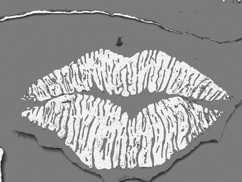 a black and white image of a rolling kiss lips