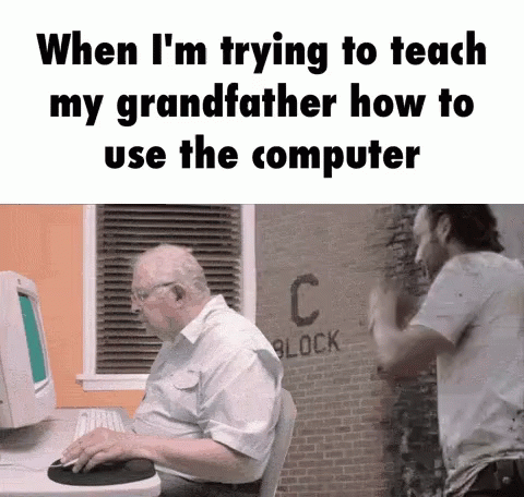 an old man sitting in front of a computer