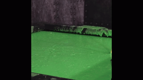 green paint is poured into the water from a machine