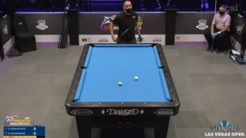 three people playing a game of pool in an arena