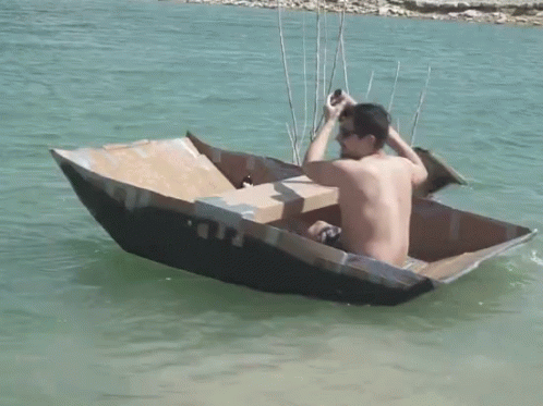 a boy sitting in a boat with two sticks sticking out of the bow