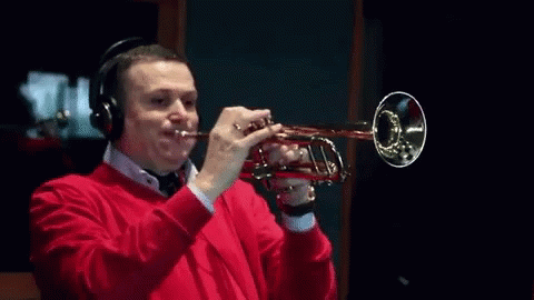 a person with headphones on playing a trumpet