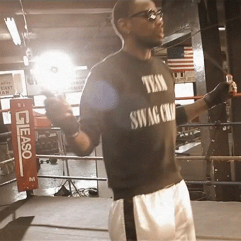 a man is boxing in the ring wearing sunglasses