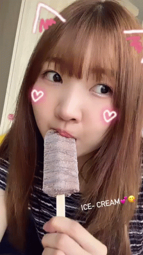 an asian girl with long hair holding a candy lolly
