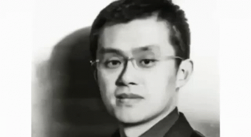 a young man in glasses looking to the side