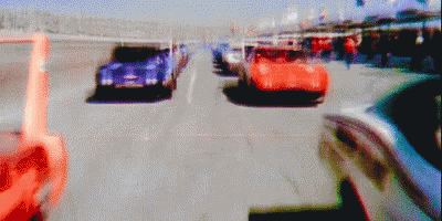 the blurred image shows three cars on an empty street