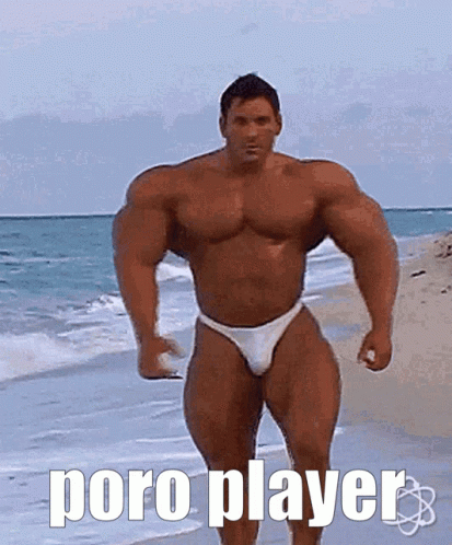 the man is standing on a beach wearing a blue and white body suit