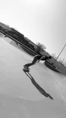 a person skating alone and in the snow