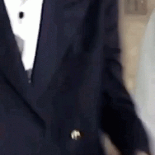 a blurry po of a man in a tuxedo