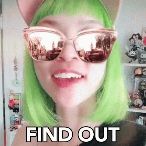 a girl with green hair wearing cat ears and round sunglasses