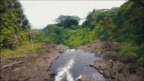 a river with rapids near the side of a hill