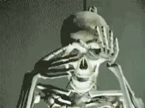 a skeleton holding his head in pain with both hands