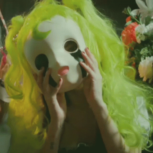the green wig of a masked mask has long blonde hair