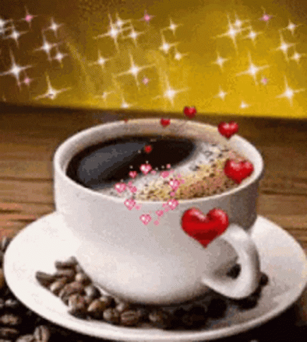 a cup of  cocoa with blue hearts and candies on it