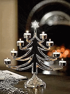 a lighted christmas tree sitting on top of a table