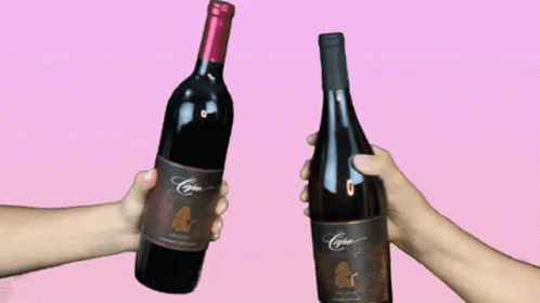 two hands hold bottles of wine while wearing fake gloves
