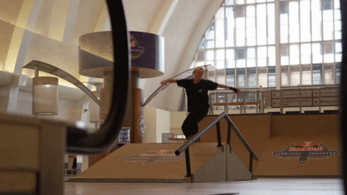 a man on a skateboard is jumping up a railing
