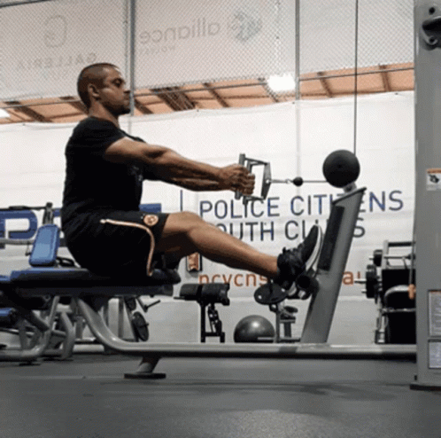 a man in a gym is exercising on a bench