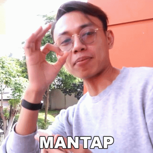mantap with two fingers up holding soing