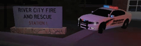 a white police car is parked in front of a sign