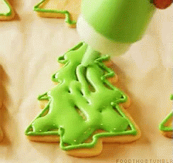 a cookie cutter and icing cutter with a christmas tree on it
