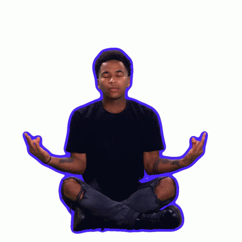 a man in black shirt sitting in lotus pose