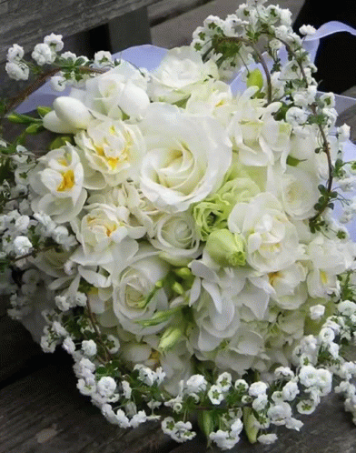 bridal bouquet is sitting on a bench