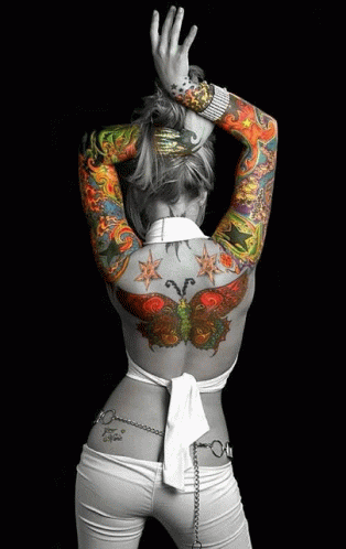 a girl is wearing tattoos on her body