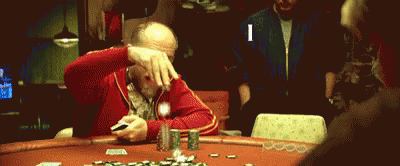 a man in blue jacket playing poker with others