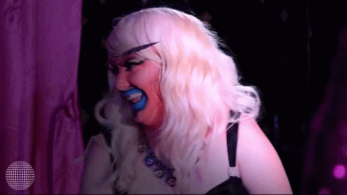 a person with blue makeup and a costume with some kind of tongue