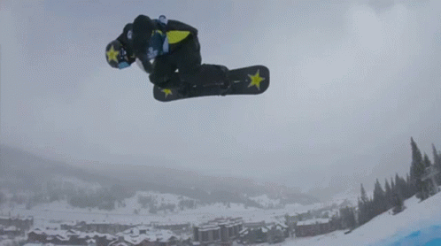 snowboarder with green accents performing a jump