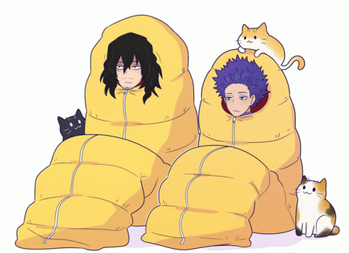 two young s sitting on giant pillows with cats nearby