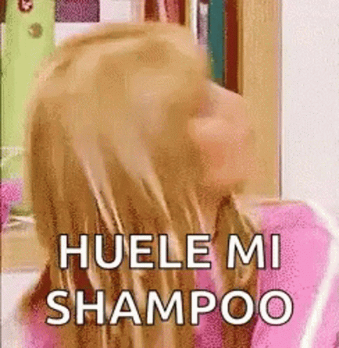 a person with long hair with the words huelemi shampoo