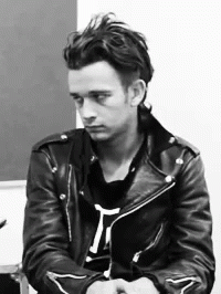man in leather jacket at a black and white po