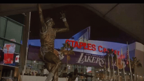 a large sign is above a statue that looks like lakers
