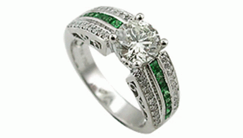 an engagement ring with two green stones and white diamonds
