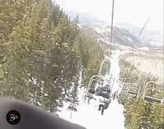 a person that is looking down at the ski lift