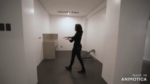 the woman is walking through the narrow hallway