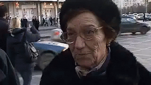 there is a very old lady with glasses and a weird face on her face