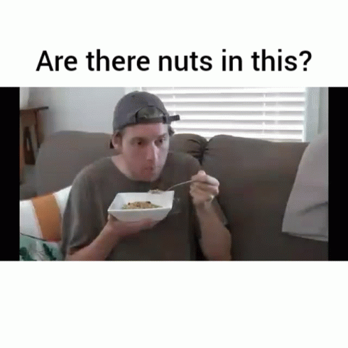 there is a man eating cereal with an awkward expression