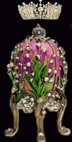 a purple egg with a green floral decoration on it and a crown