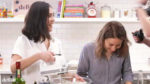 three girls doing different tasks in the kitchen