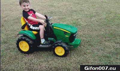 a little boy that is sitting in a toy tractor