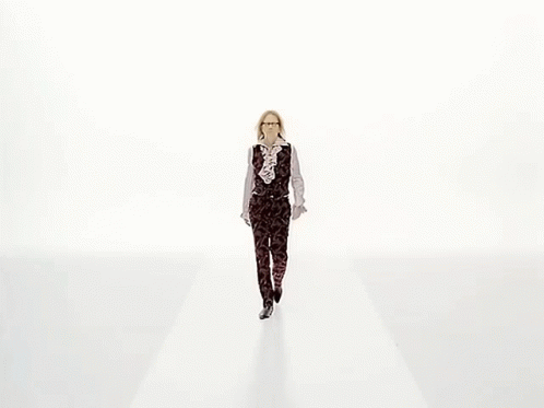 a person walks down the runway at a fashion show