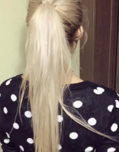 a girl with long hair and polka dot shirt