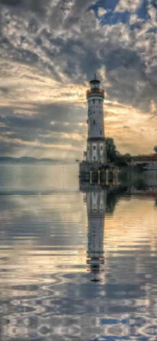 a po of a light house sits in the water